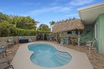 Back yard of the home with private fenced pool  tiki hut to make yourself right at home at
